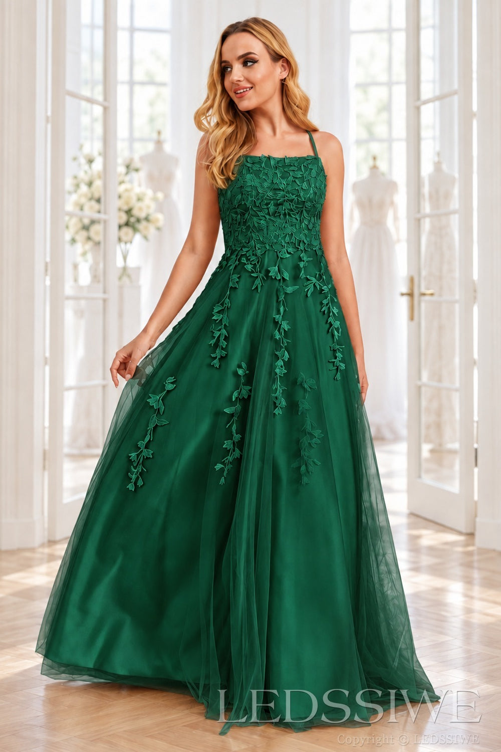 Emerald tulle a-line prom dress with lace appliqués and lace-up back