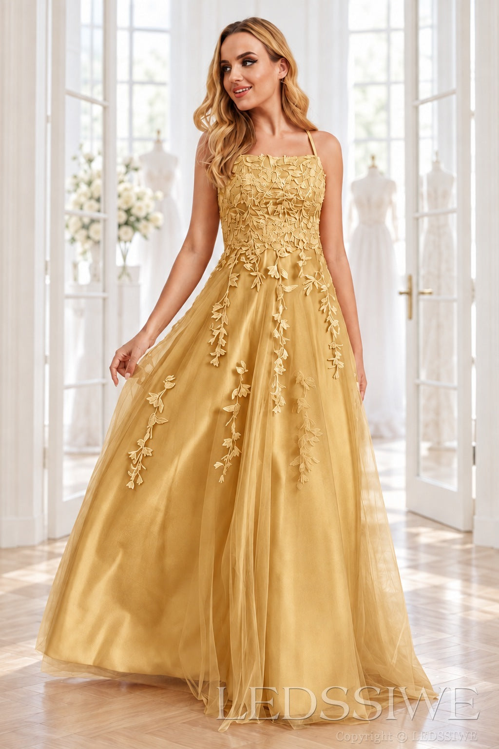 Gold tulle a-line prom dress with lace appliqués and lace-up back