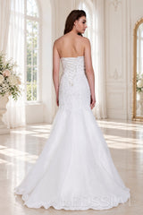 ivory strapless beaded mermaid wedding dress with layered tulle skirt back view