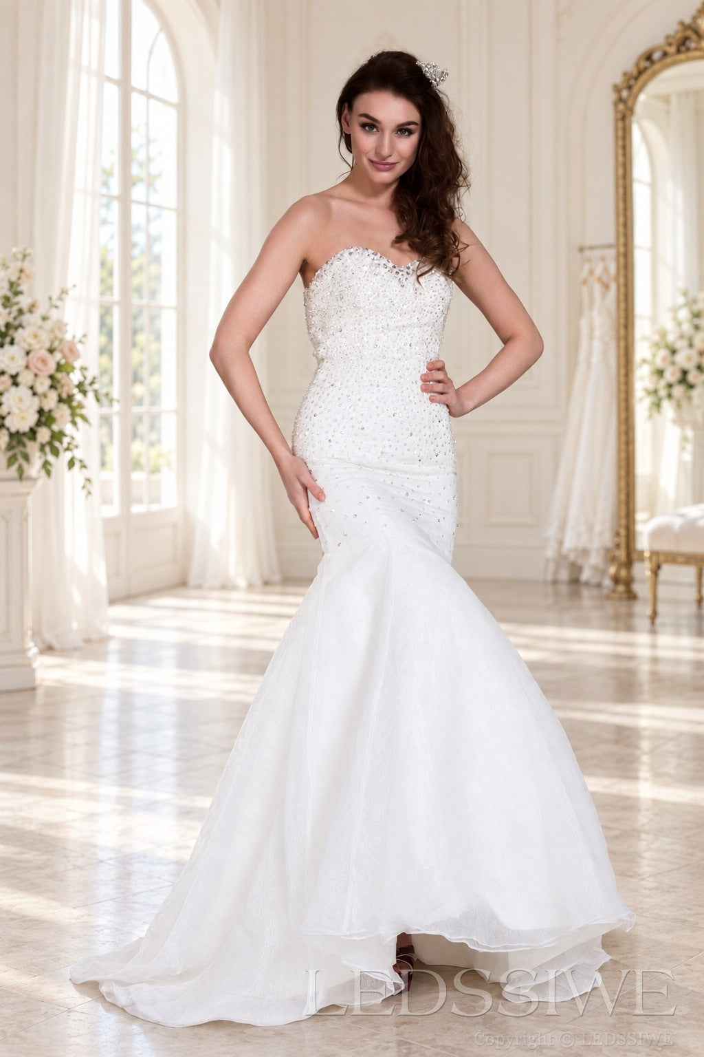 ivory strapless beaded mermaid wedding dress with layered tulle skirt front view