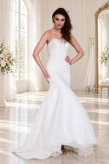 ivory strapless beaded mermaid wedding dress with layered tulle skirt front view