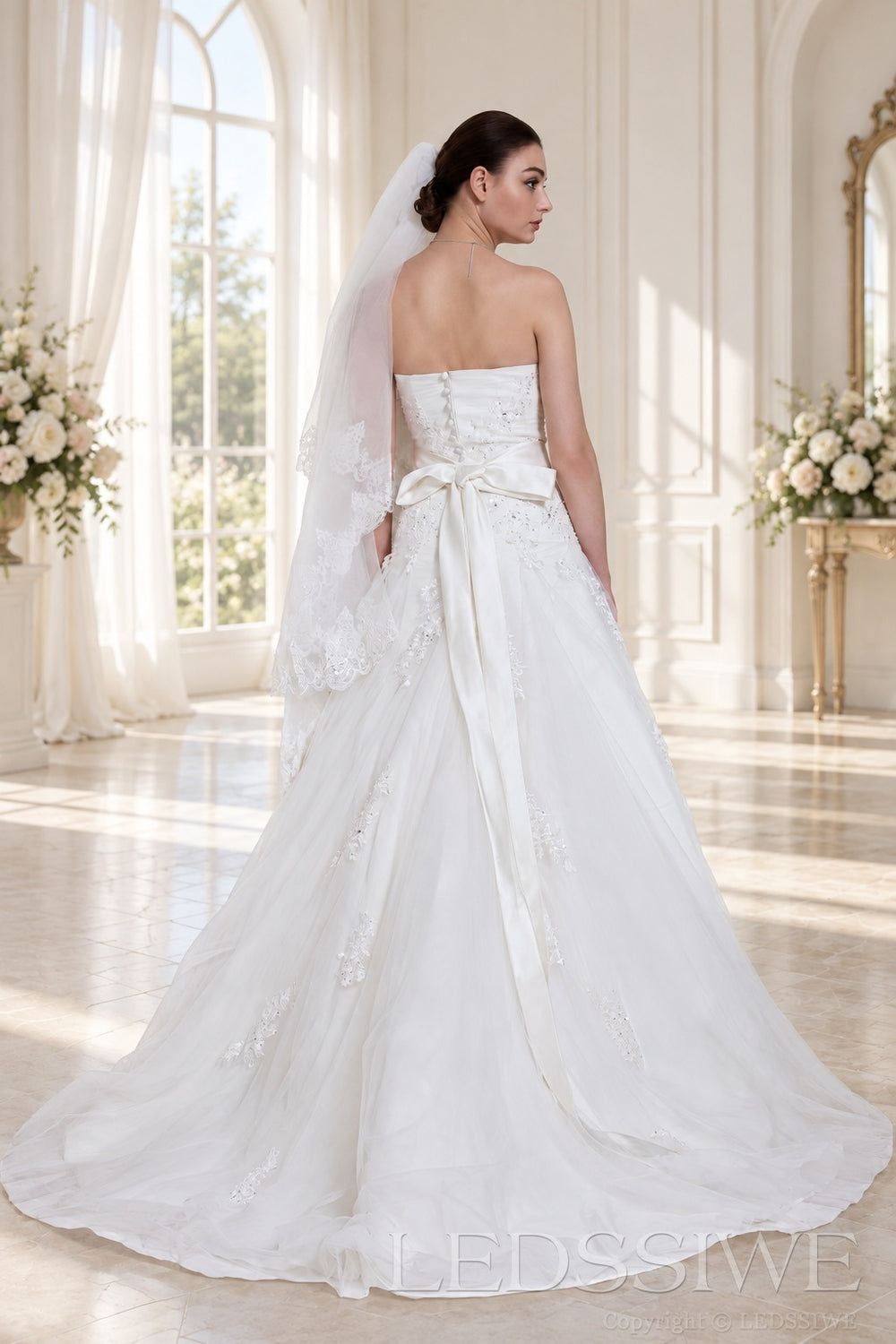 ivory strapless beaded lace ball gown wedding dress with waist brooch back view