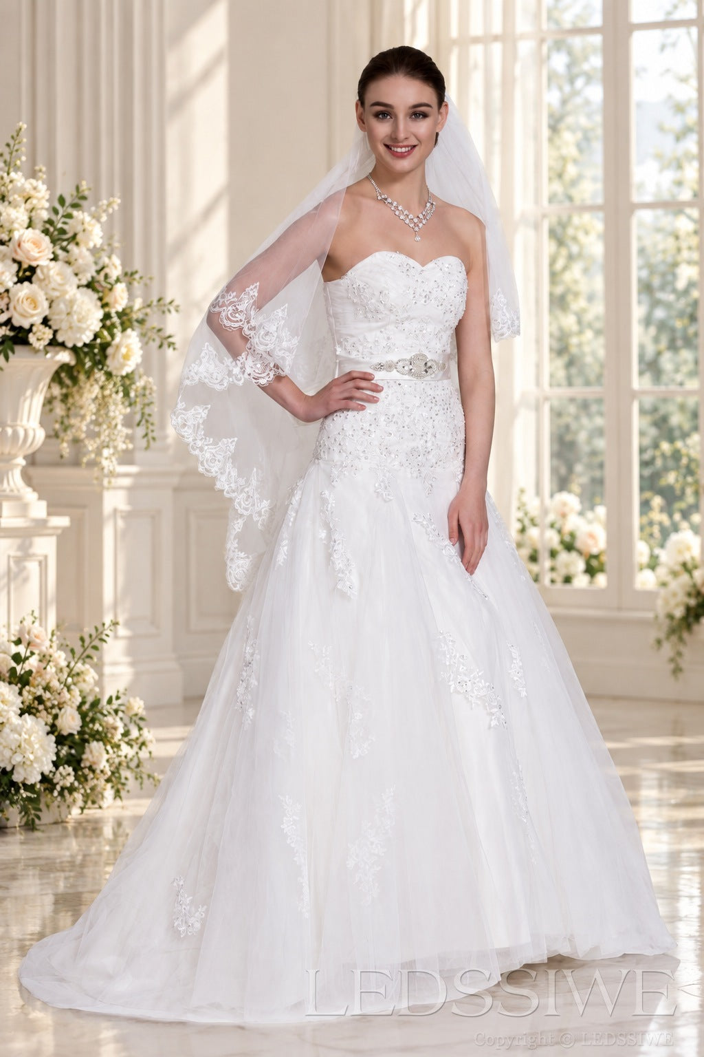 ivory strapless beaded lace ball gown wedding dress with waist brooch side view