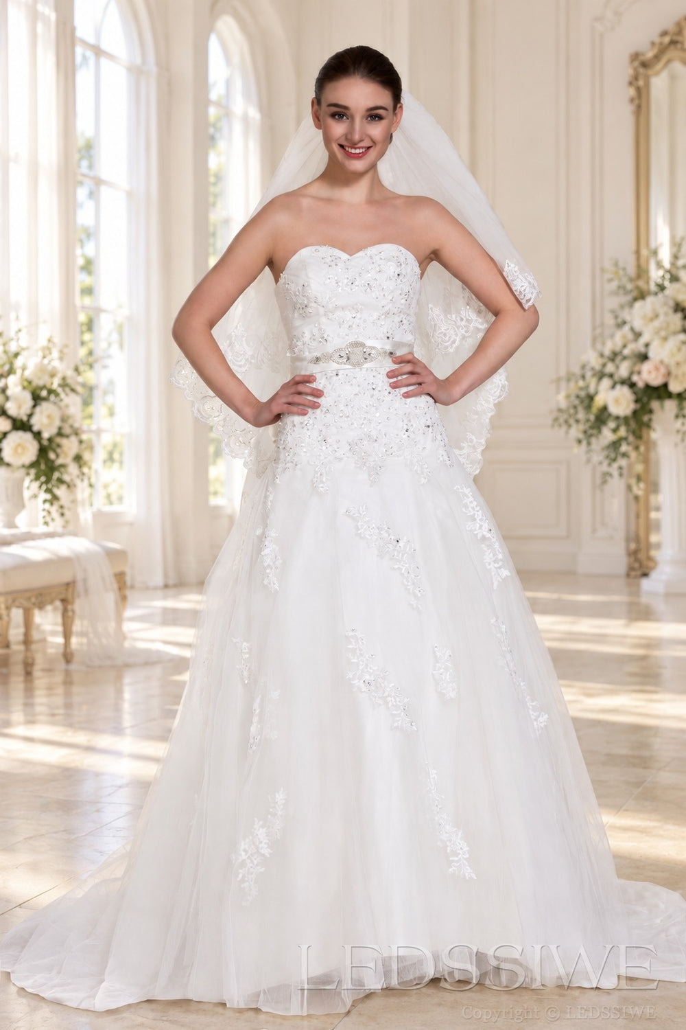 ivory strapless beaded lace ball gown wedding dress with waist brooch front view