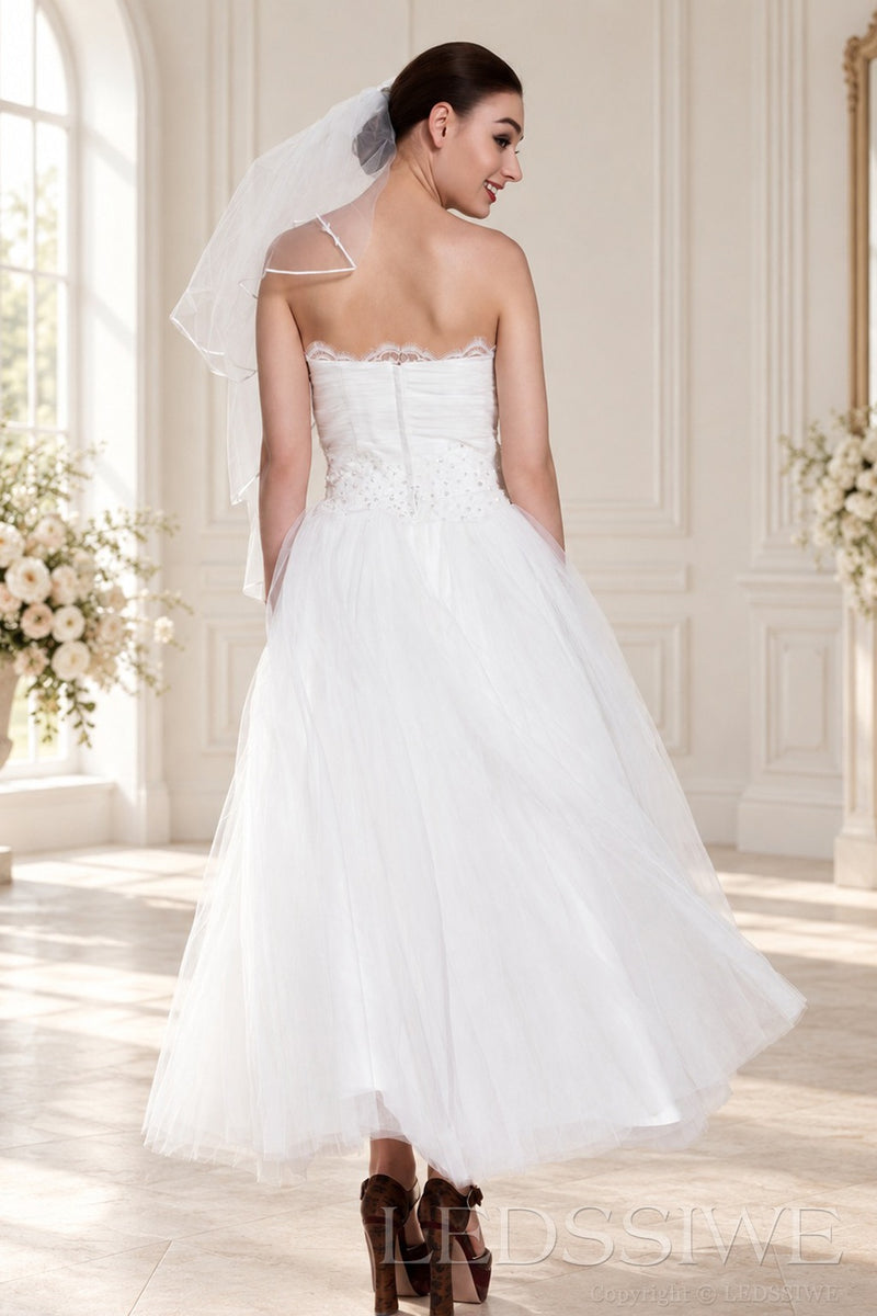 ivory strapless tulle tea length wedding dress with beaded waist and veil back view