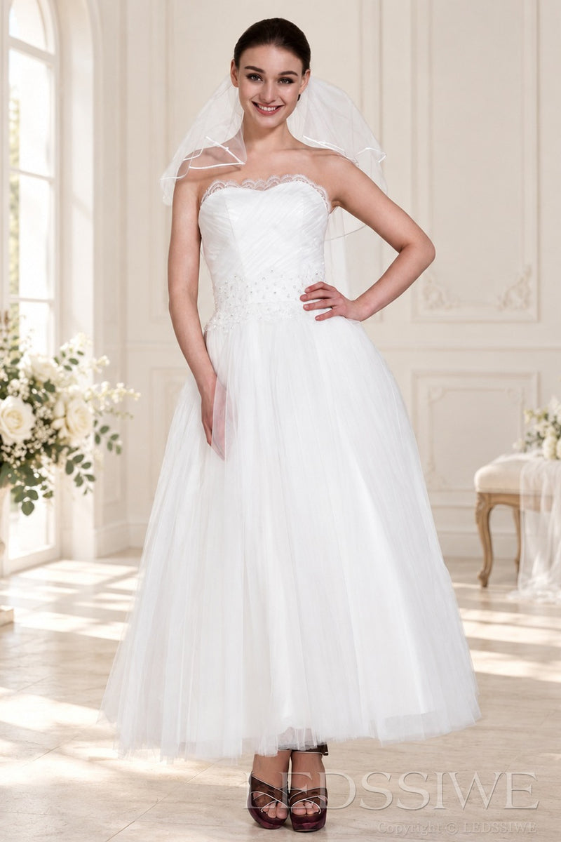 ivory strapless tulle tea length wedding dress with beaded waist and veil front view