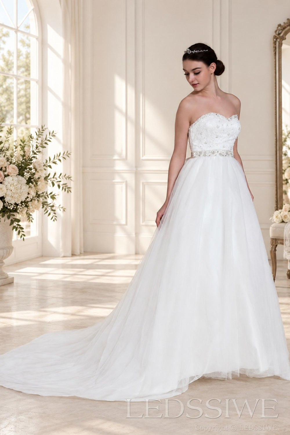 ivory spaghetti strap beaded tulle a-line wedding dress with jeweled belt three-quarter view