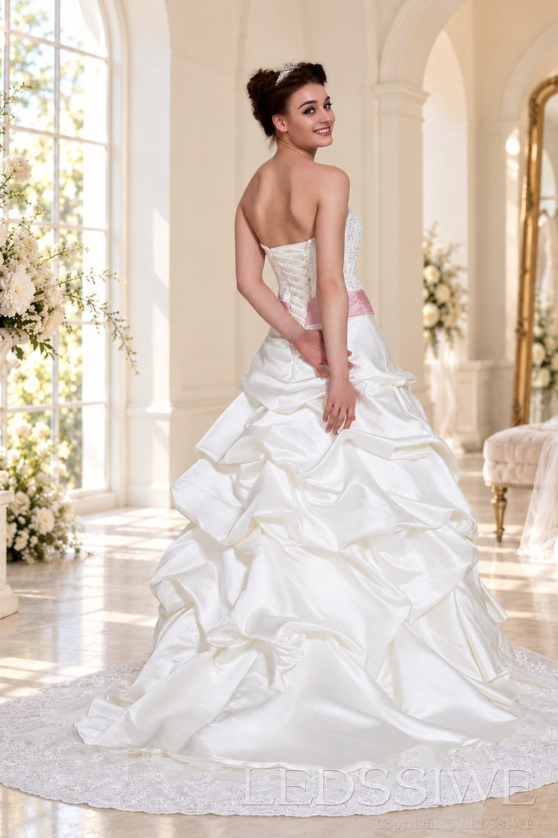 ivory strapless beaded lace ball gown wedding dress with pink satin bow sash back view